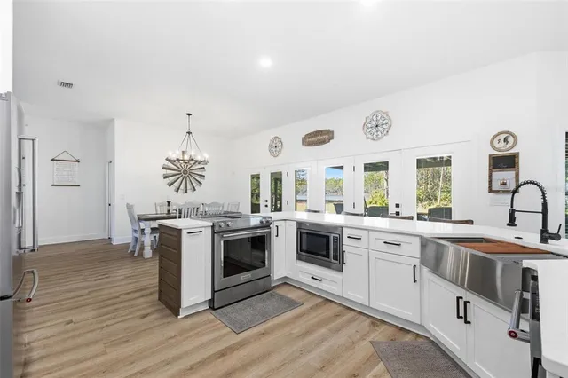 a kitchen with cabinets and stainless steel appliances