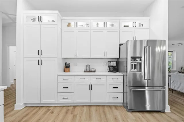 a living room with furniture a fireplace and a large window
