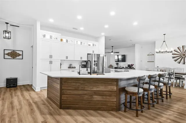 a view of a dining room with furniture and a chandelier