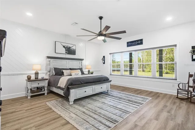 a bedroom with a bed and a ceiling fan