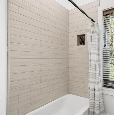a living room with hardwood floor and a flat screen tv