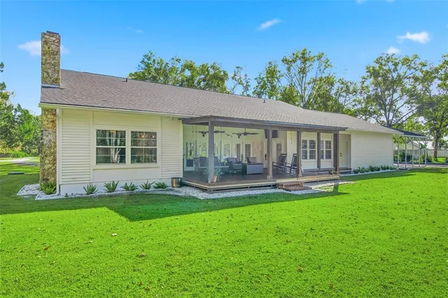 an aerial view of a house with a yard table and chairs