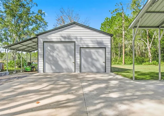 a view of a house with a yard and sitting area