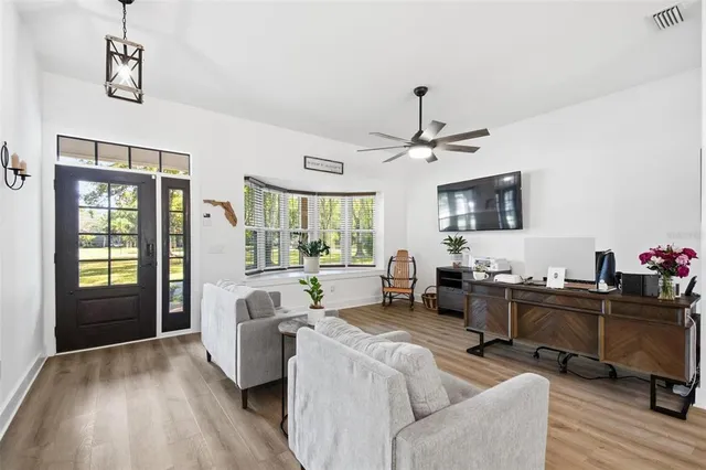 a view of a dining room with furniture window and wooden floor