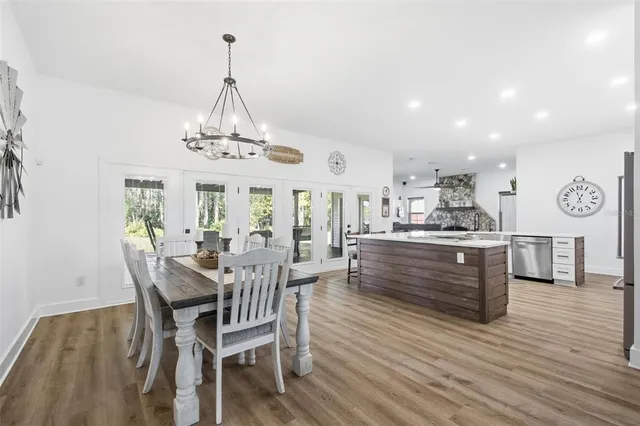 a view of a dining room with furniture wooden floor and chandelier