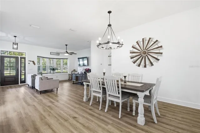 a large kitchen with a table and chairs