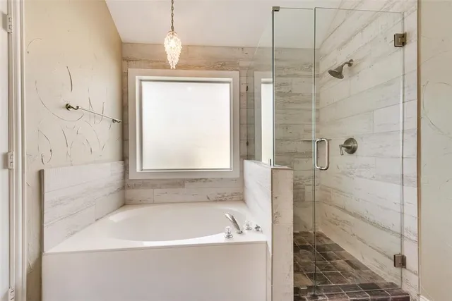 a bathroom with a bathtub and a shower