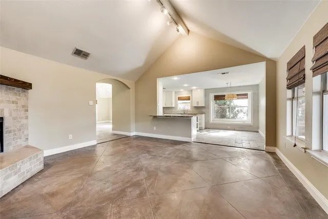 a view of an empty room with a fireplace