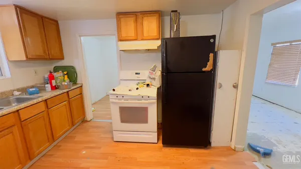 a kitchen with stainless steel appliances granite countertop a refrigerator and a stove