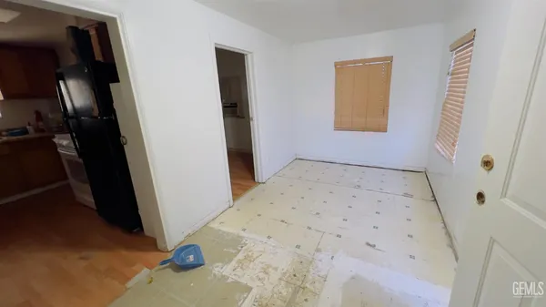 a view of a room with wooden floor and a sink