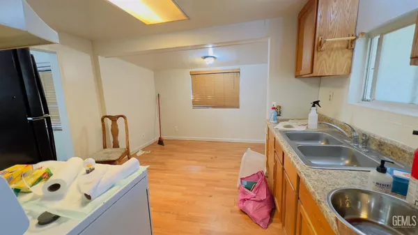 a kitchen with stainless steel appliances granite countertop a refrigerator and a sink