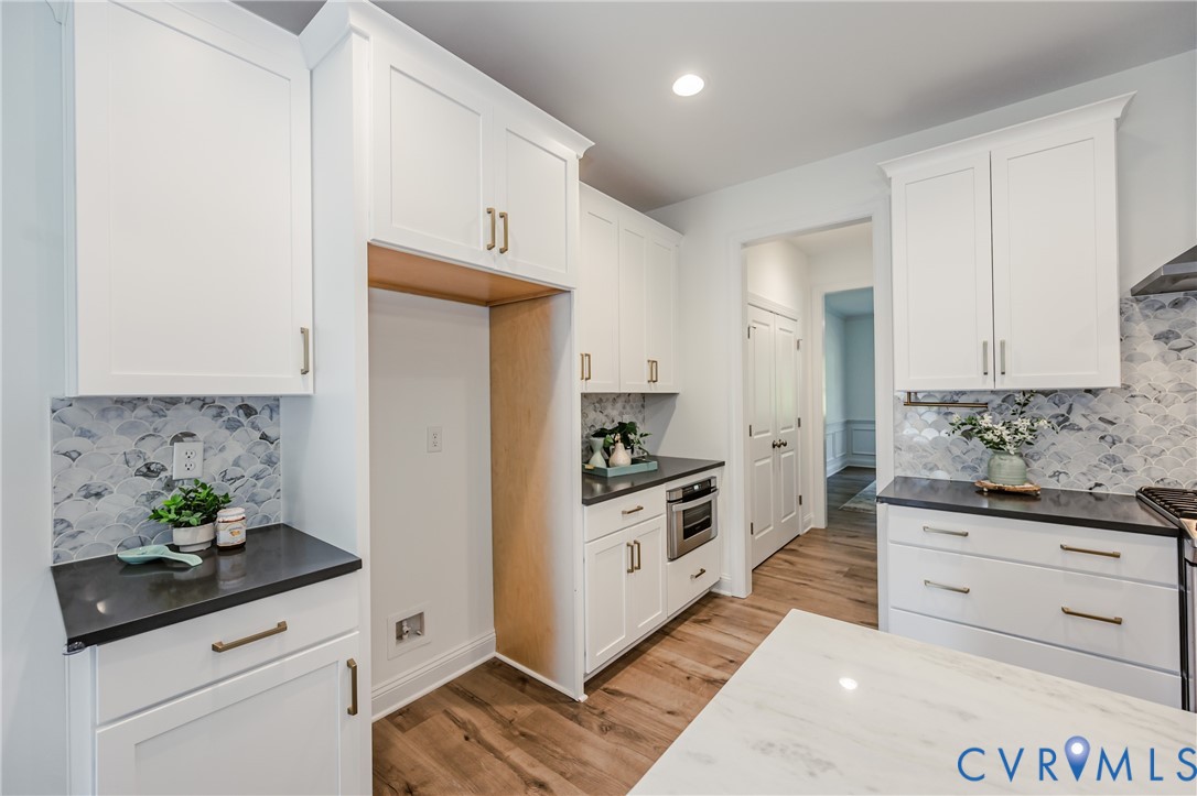 720 Chapman Street Ashland, VA 23005 - Photo 16 of 50 a kitchen with white cabinets and stainless steel appliances