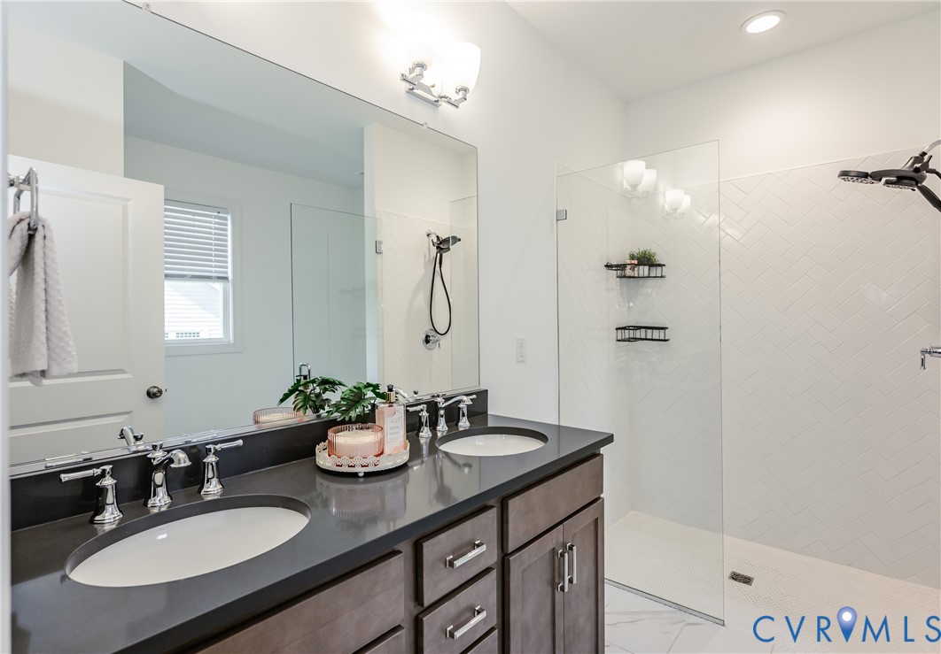 720 Chapman Street Ashland, VA 23005 - Photo 32 of 50 a bathroom with a granite countertop sink a mirror and a shower