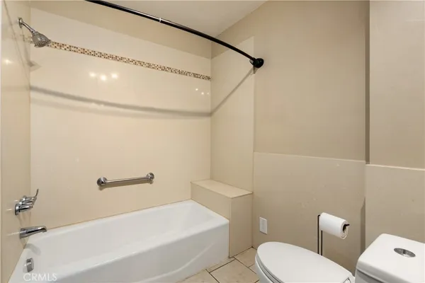 a bathroom with a white toilet and a bathtub