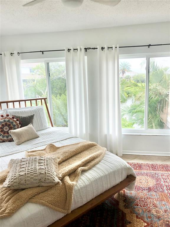 835 East Gulf Boulevard, Unit 101 Indian Rocks Beach, FL 33785 - Photo 15 of 21 a bedroom with a large bed and a large window