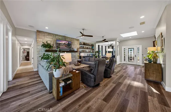 a living room with furniture or wooden floor and a potted plant