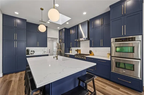 a kitchen with a table chairs microwave and cabinets