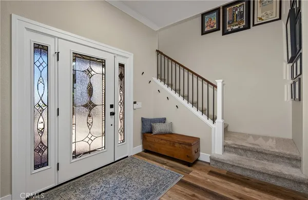 a view of front door with wooden floor and stairs