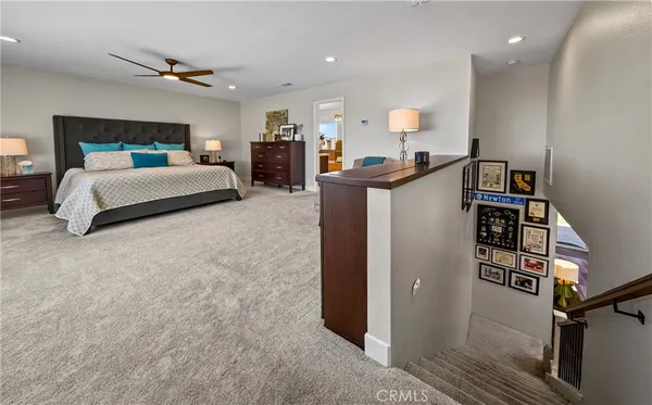 a bedroom with bed and a chandelier