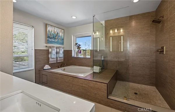 a bathroom with a granite countertop sink a toilet and shower