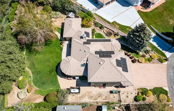 an aerial view of a house with a garden and trees