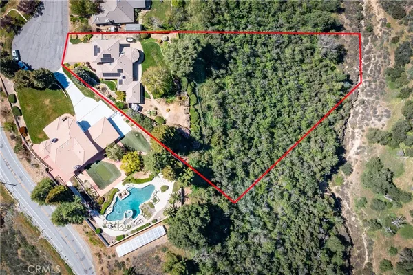 an aerial view of residential house with outdoor space and swimming pool