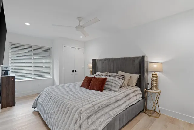 a bedroom with bed and a night stand