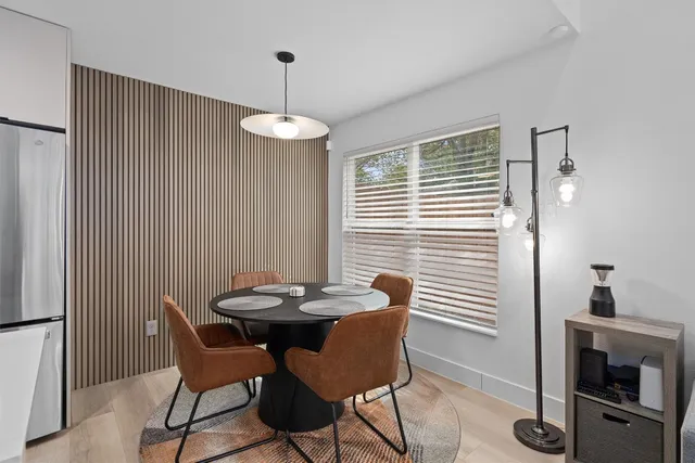 a view of a dining room with furniture wooden floor and a chandelier
