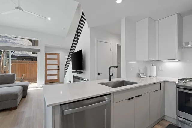 a kitchen with a sink stove and cabinets