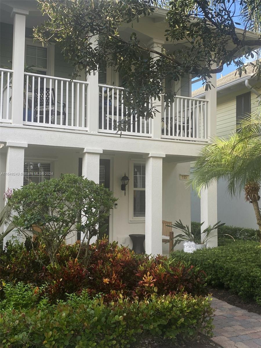 155 Soriano Drive, Unit 155 Jupiter, FL 33458 - Photo 1 of 29 front view of a house with a yard