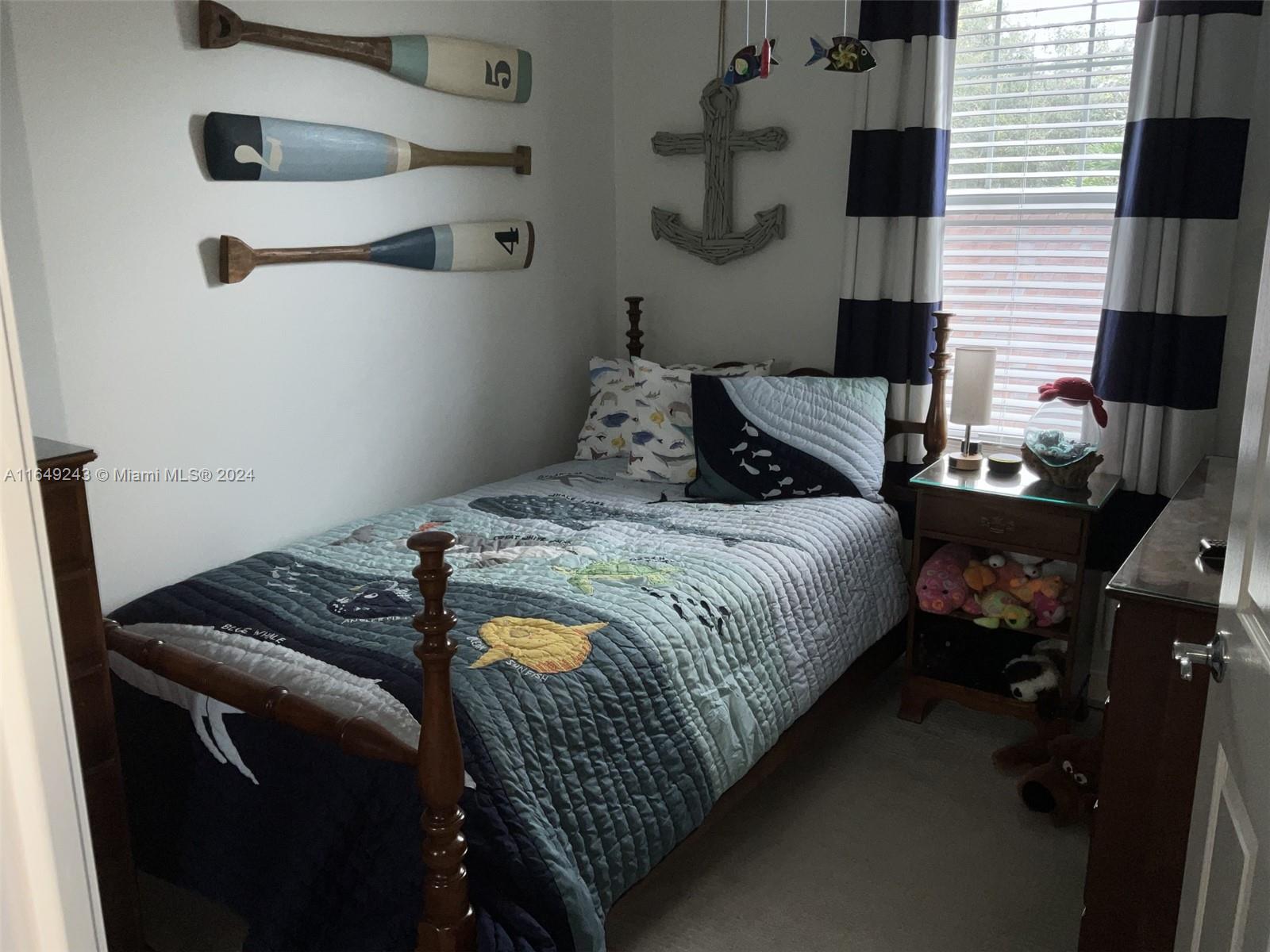 155 Soriano Drive, Unit 155 Jupiter, FL 33458 - Photo 11 of 29 a bedroom with a bed and a flat tv screen