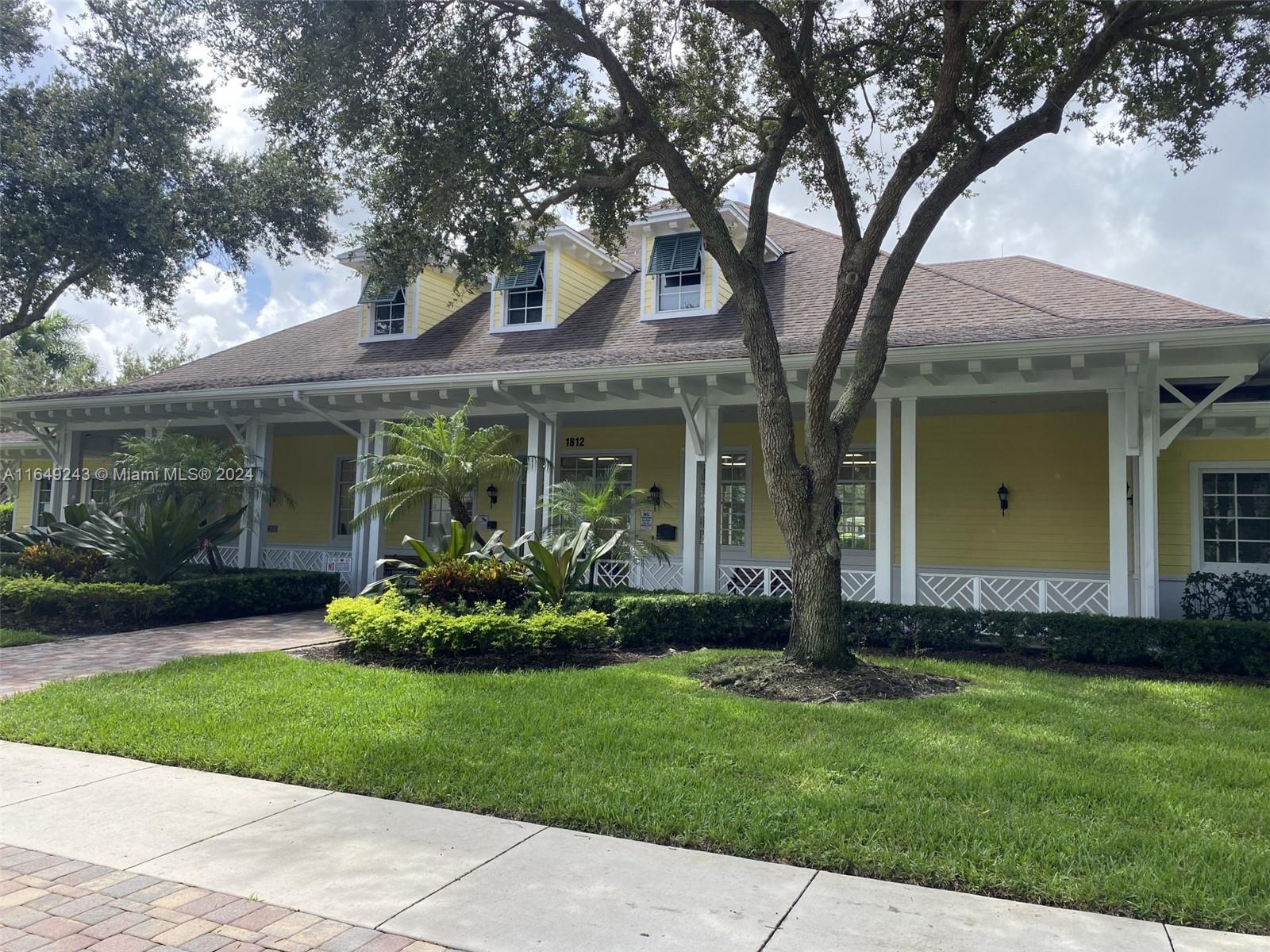155 Soriano Drive, Unit 155 Jupiter, FL 33458 - Photo 24 of 29 front view of a house with a yard