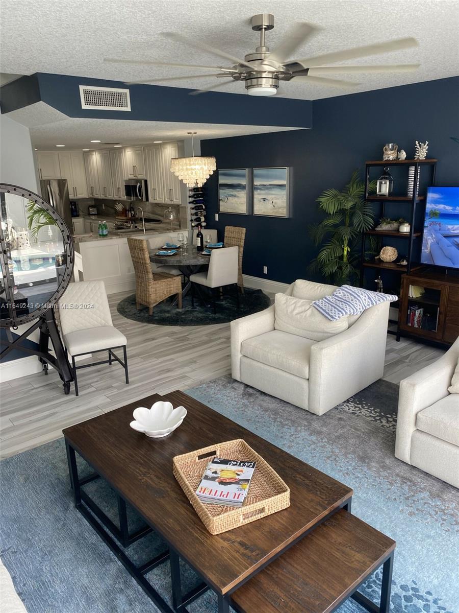 155 Soriano Drive, Unit 155 Jupiter, FL 33458 - Photo 4 of 29 a living room with furniture and a dining table