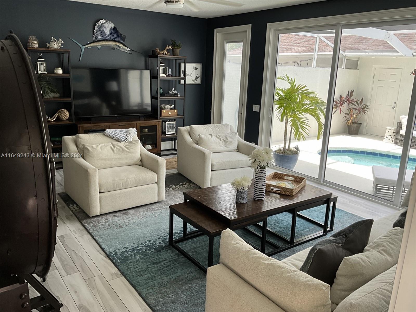 155 Soriano Drive, Unit 155 Jupiter, FL 33458 - Photo 6 of 29 a living room with furniture and a flat screen tv