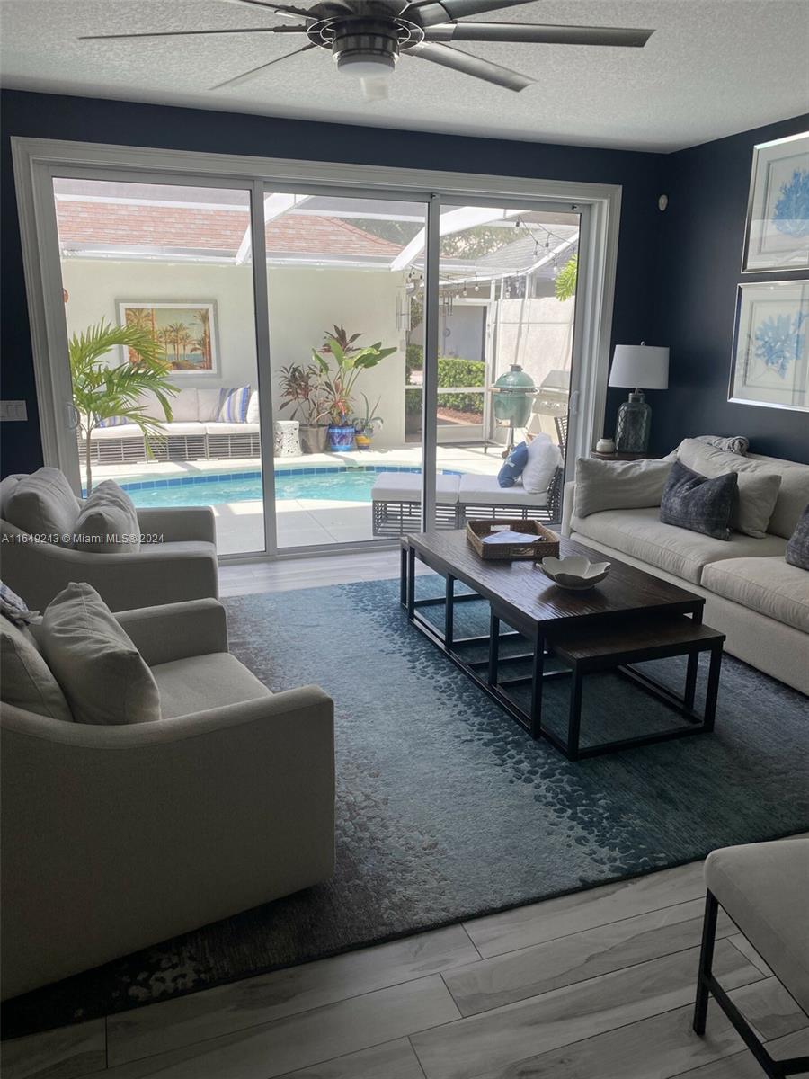 155 Soriano Drive, Unit 155 Jupiter, FL 33458 - Photo 7 of 29 a living room with furniture and a large window