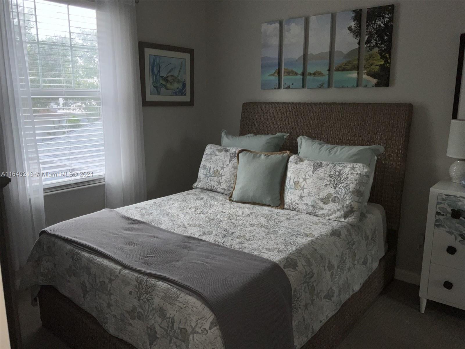 155 Soriano Drive, Unit 155 Jupiter, FL 33458 - Photo 10 of 29 a bedroom with a bed and a window