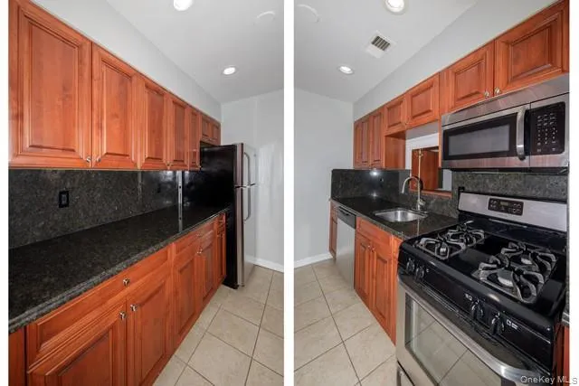a kitchen with stainless steel appliances granite countertop a stove a sink and a refrigerator