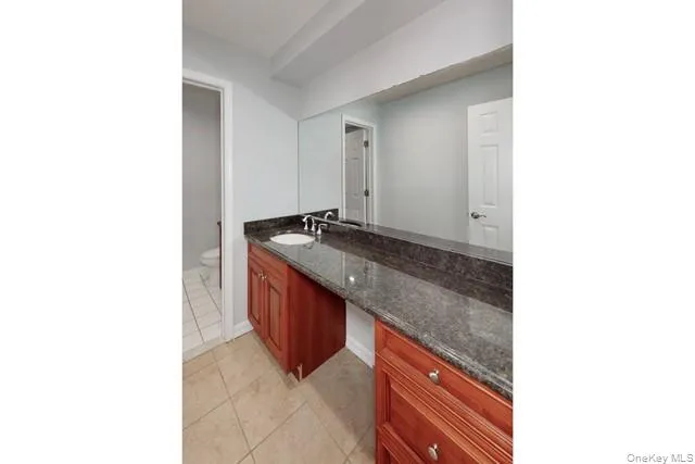 a kitchen with granite countertop a sink and a stove