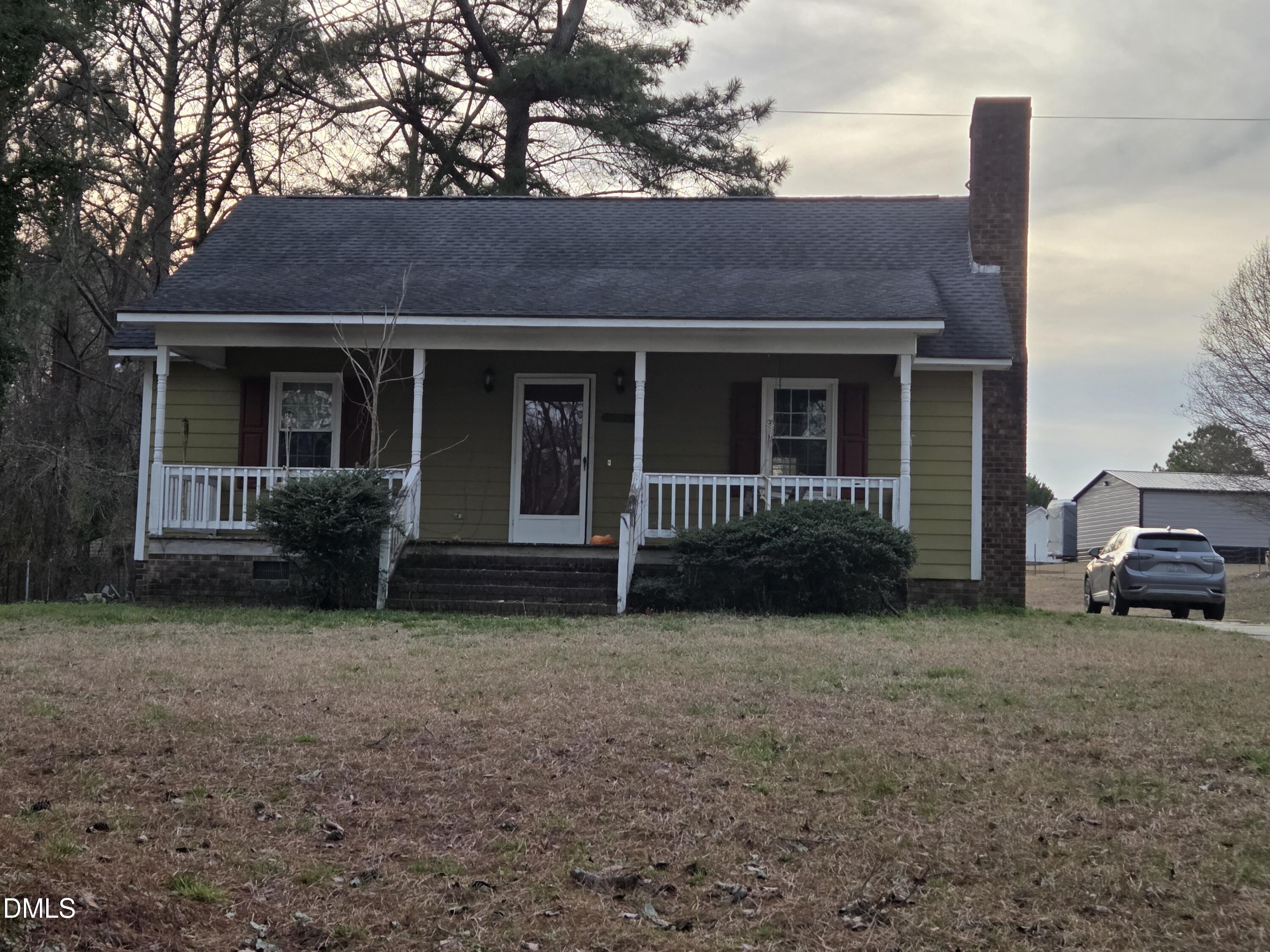 727 North Orange Street Coats, NC 27521 - Photo 1 of 14 a view of a house with a yard and a large tree