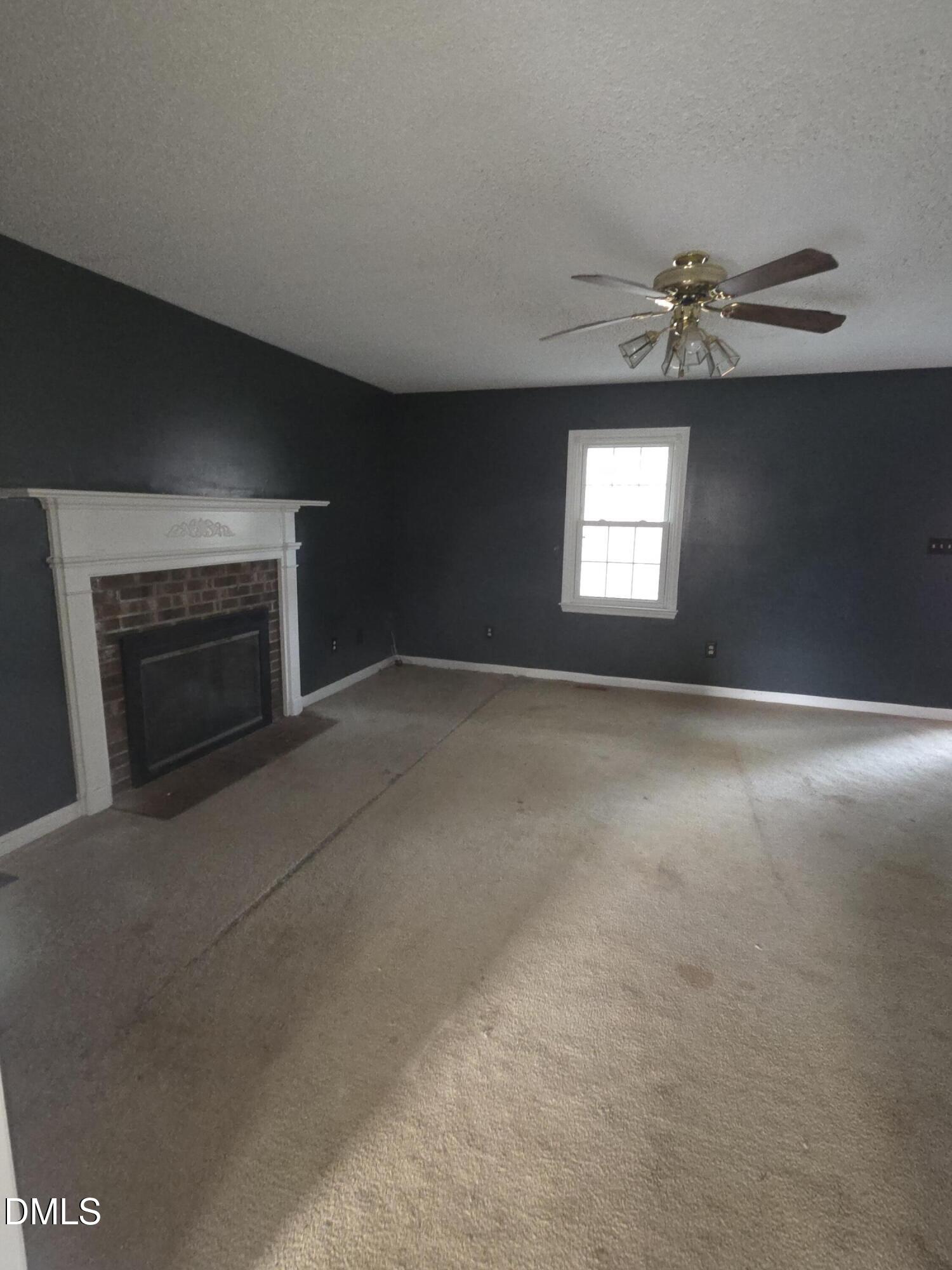 727 North Orange Street Coats, NC 27521 - Photo 11 of 14 a view of empty room with a fireplace