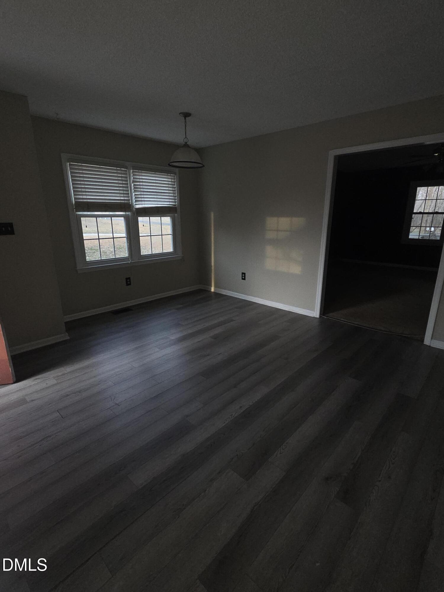 727 North Orange Street Coats, NC 27521 - Photo 14 of 14 a view of an empty room with wooden floor and a window
