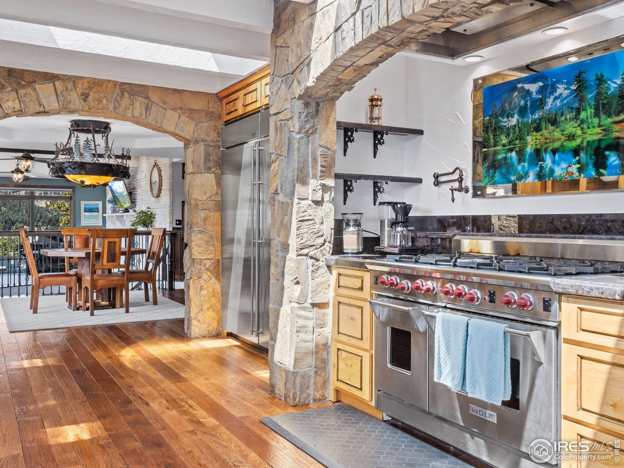 2701 Fall River Road Estes Park, CO 80517 - Photo 12 of 40 a kitchen with stainless steel appliances granite countertop a stove and a refrigerator