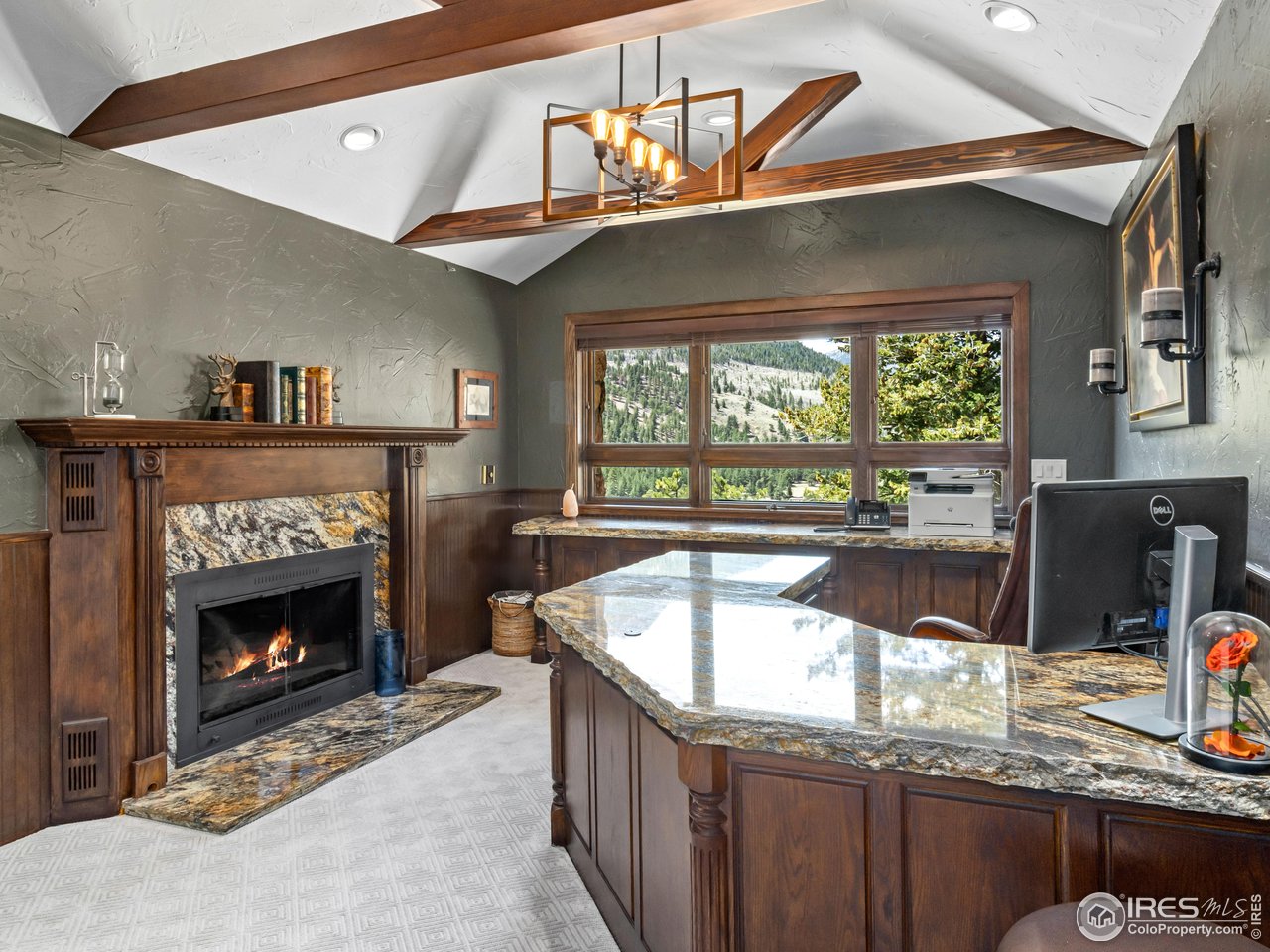 2701 Fall River Road Estes Park, CO 80517 - Photo 27 of 40 a kitchen with a sink a counter top space and a fireplace
