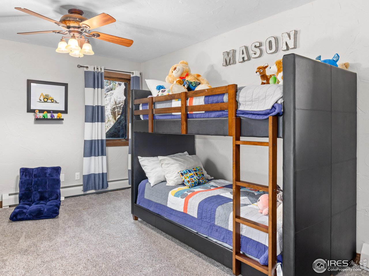 2701 Fall River Road Estes Park, CO 80517 - Photo 30 of 40 a bedroom with a bed and a chandelier