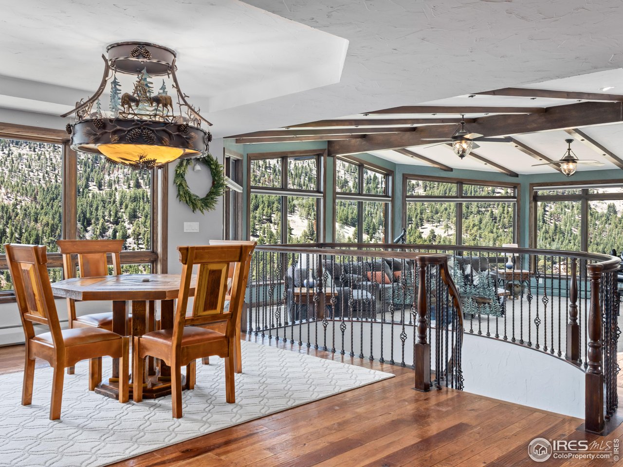 2701 Fall River Road Estes Park, CO 80517 - Photo 10 of 40 a view of a dining room with furniture window and wooden floor