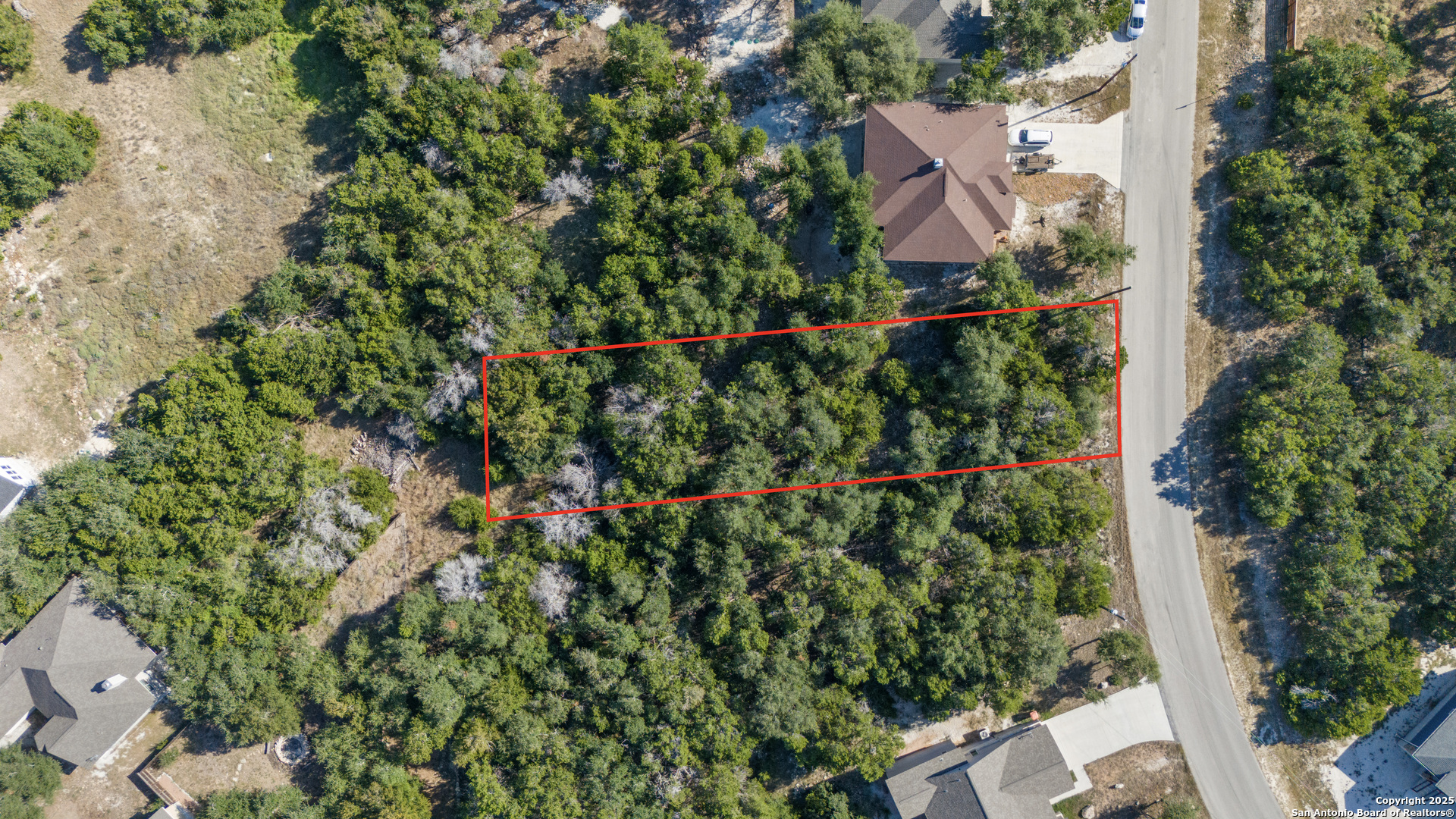 1483 Redwood Road Fischer, TX 78623 - Photo 9 of 13 an aerial view of residential house with outdoor space and trees all around