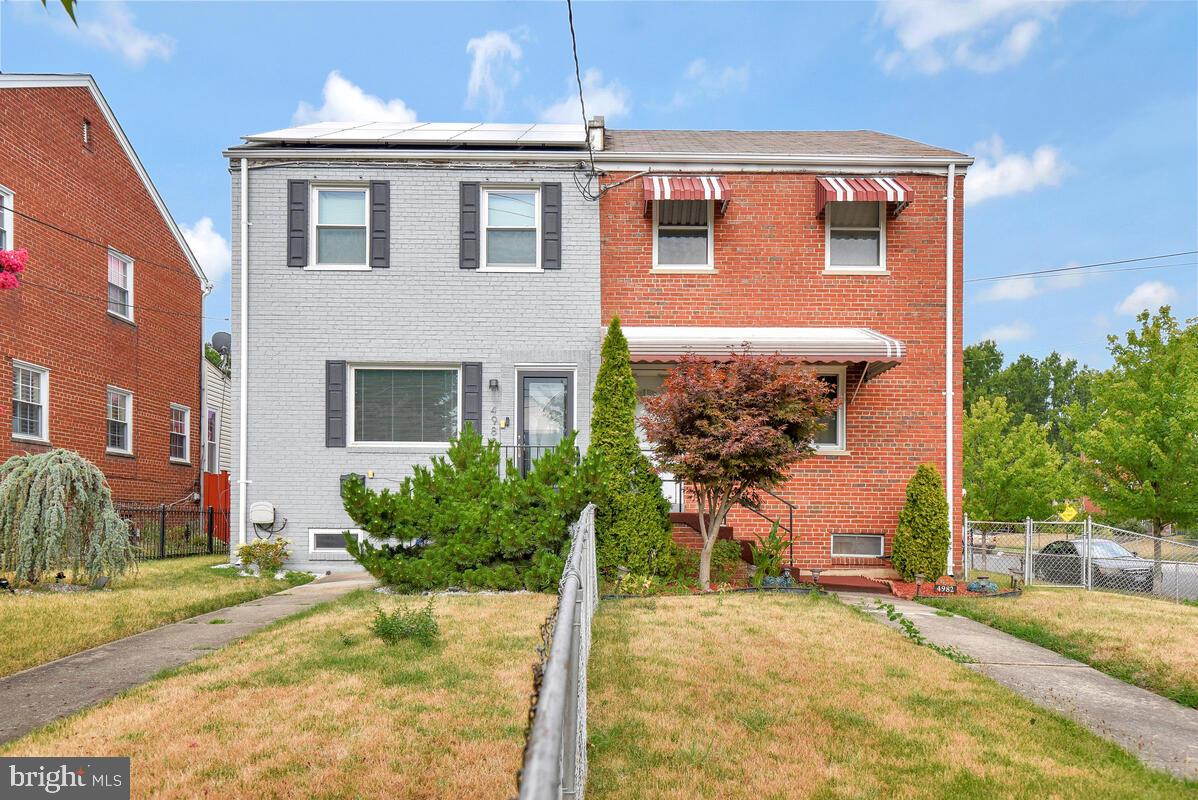 4982 Sargent Road Northeast Washington, DC 20017 - Photo 1 of 35 a front view of a house with a yard and garage