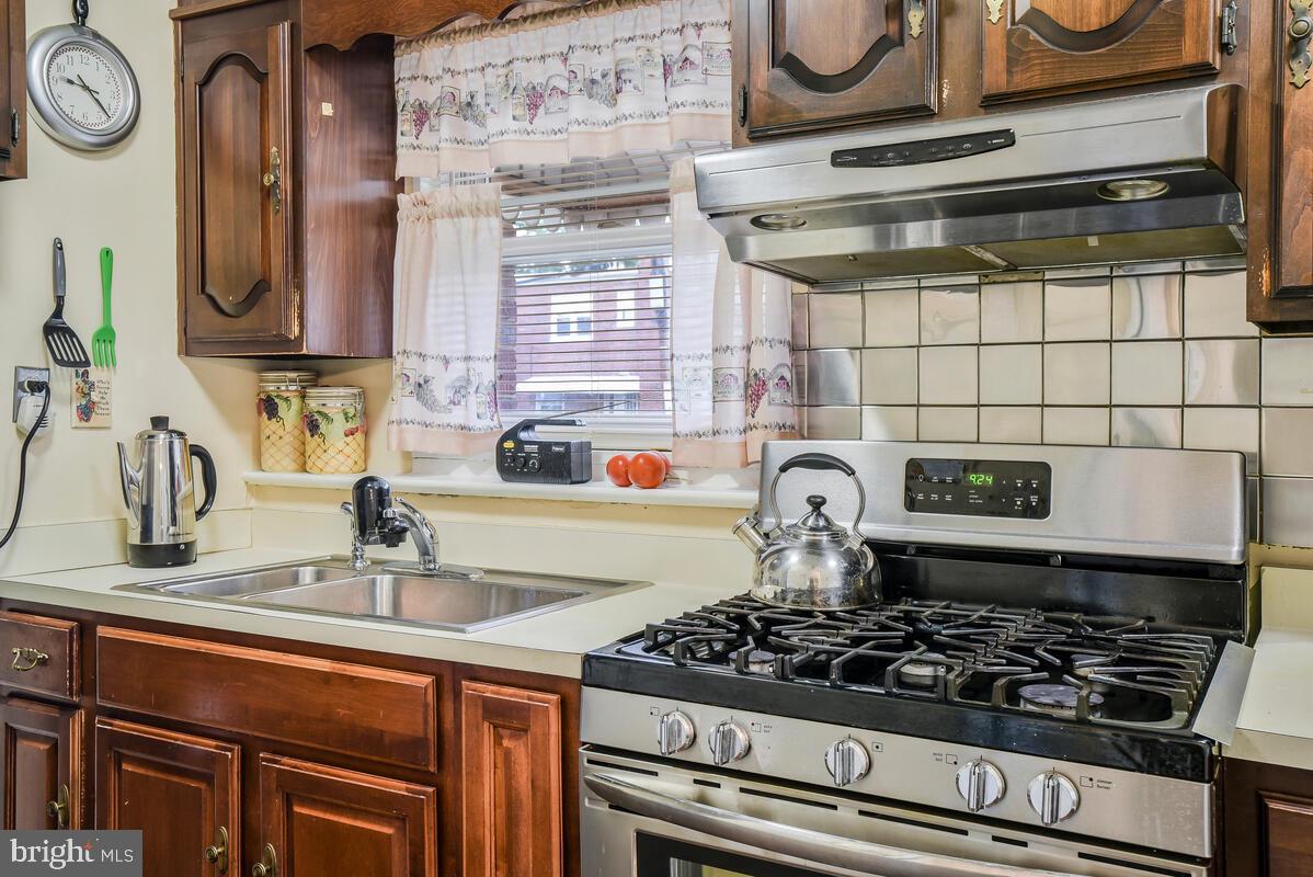 4982 Sargent Road Northeast Washington, DC 20017 - Photo 16 of 35 a kitchen with a stove and a sink