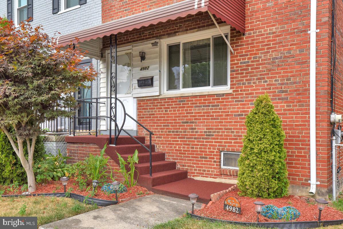 4982 Sargent Road Northeast Washington, DC 20017 - Photo 2 of 35 a front view of a house with garden