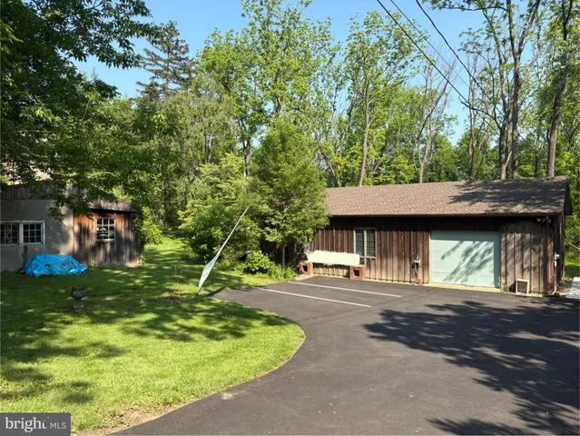 a backyard of a house with yard and trampoline